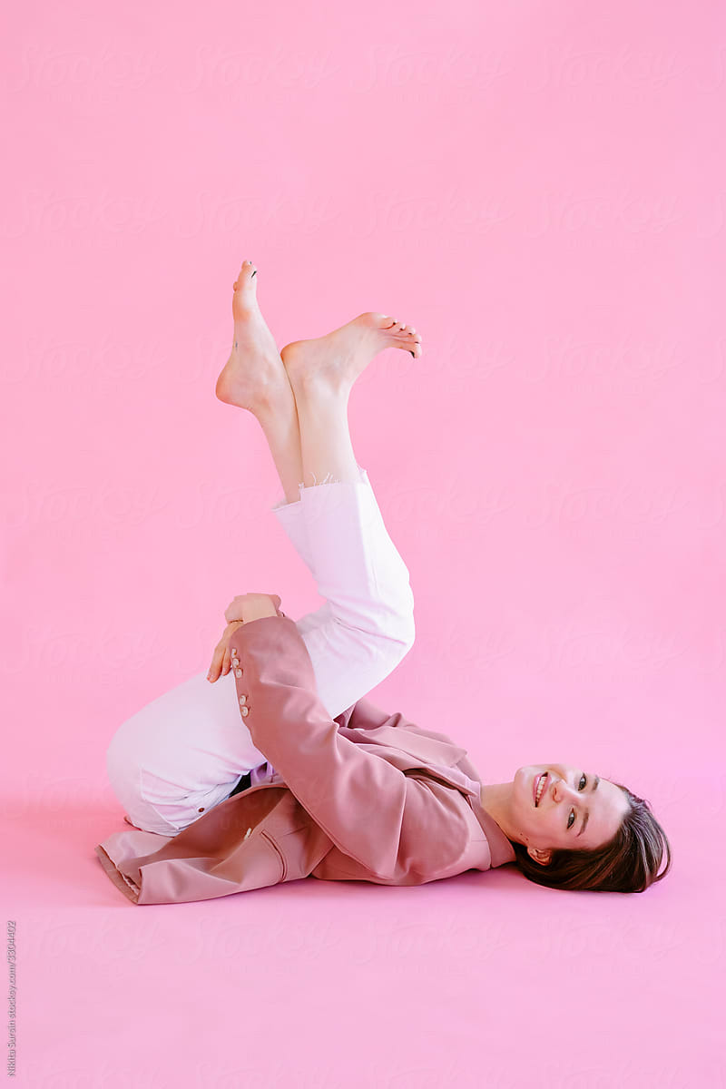 bright teenage girl posing in studio on pink background