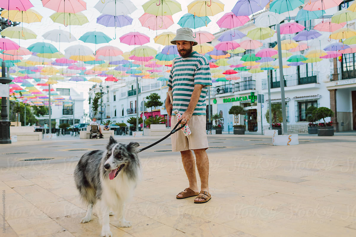 Man and his dog in the central square of a town