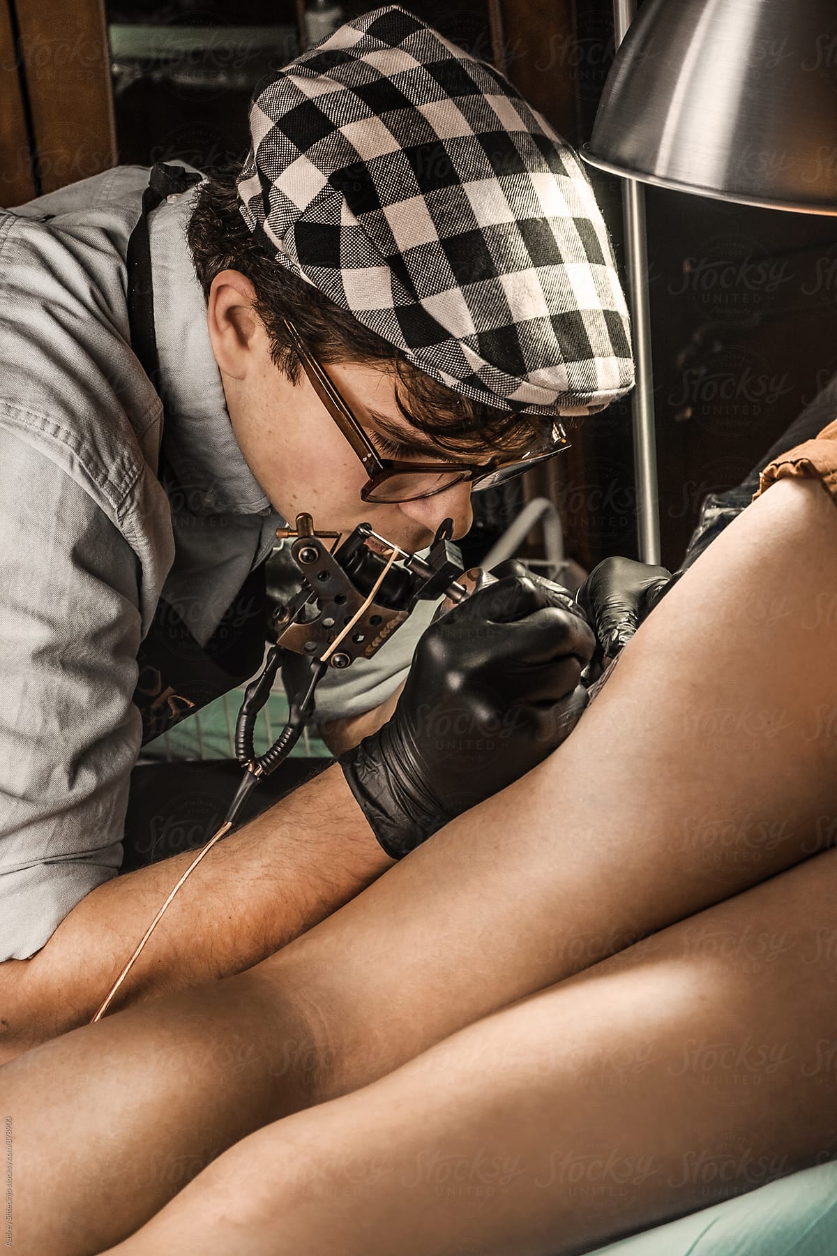 Tattoo session in vintage tatto studio.