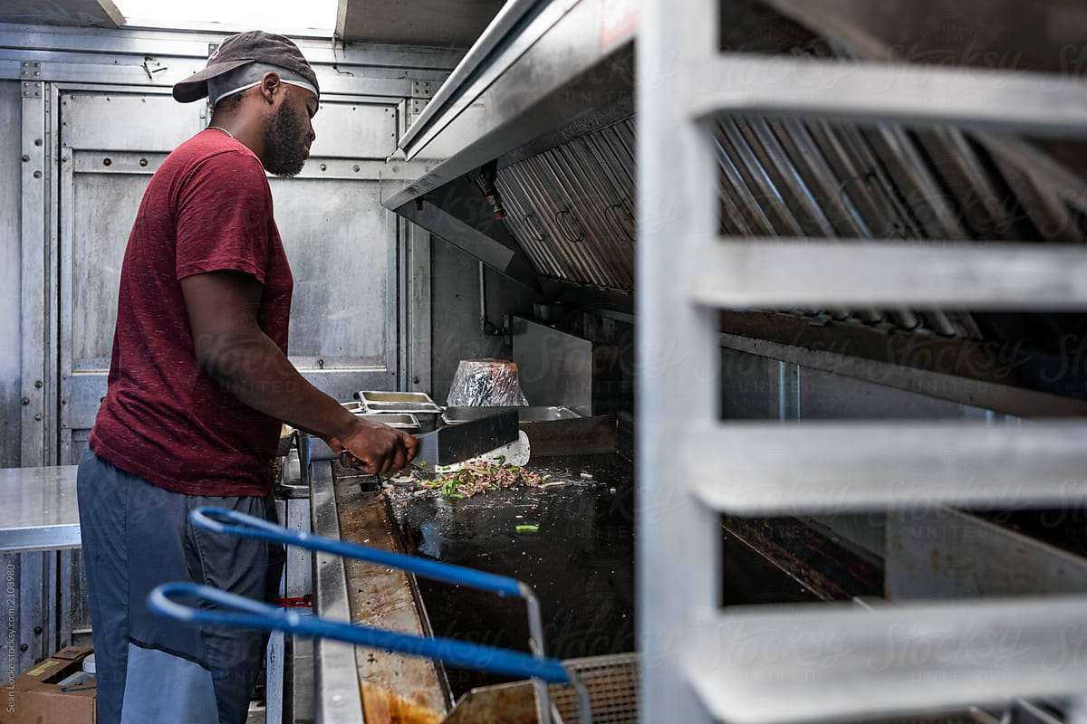 Food Truck: Man Cooking Steak And Vegetables On Grill