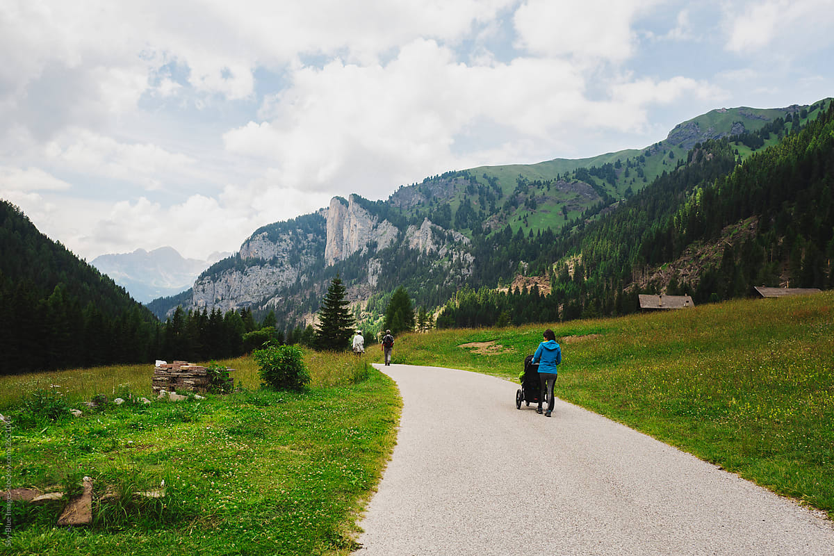 Mother walking in an alpine terrain using a jogging stroller