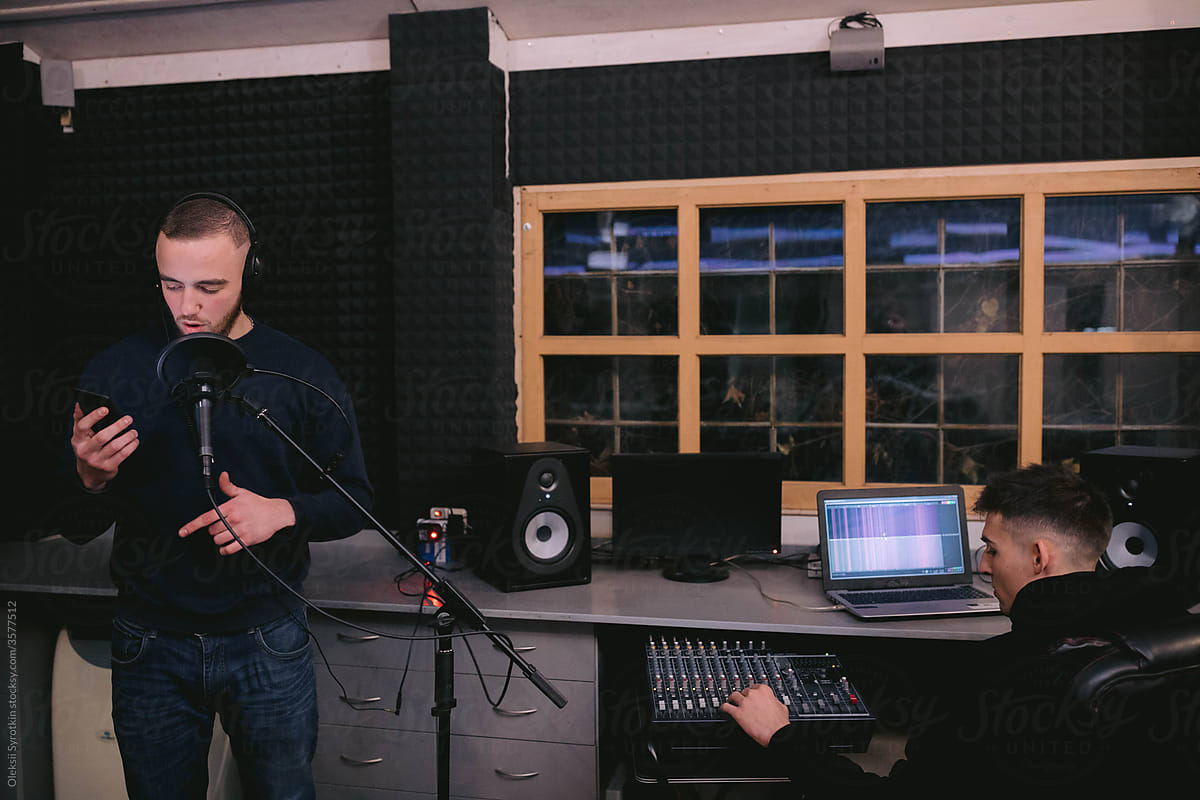 Men creating music in recording studio