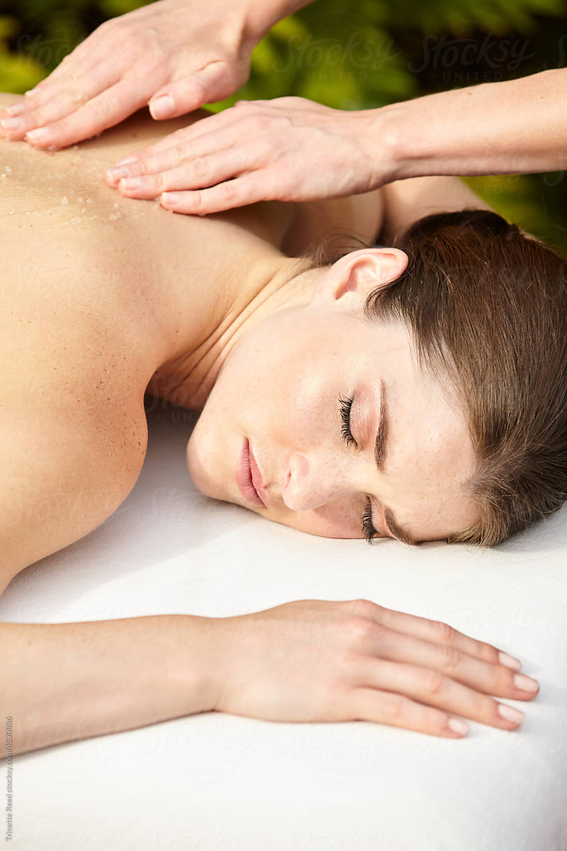 Close-up of woman receiving an exfoliating scrub massage at spa