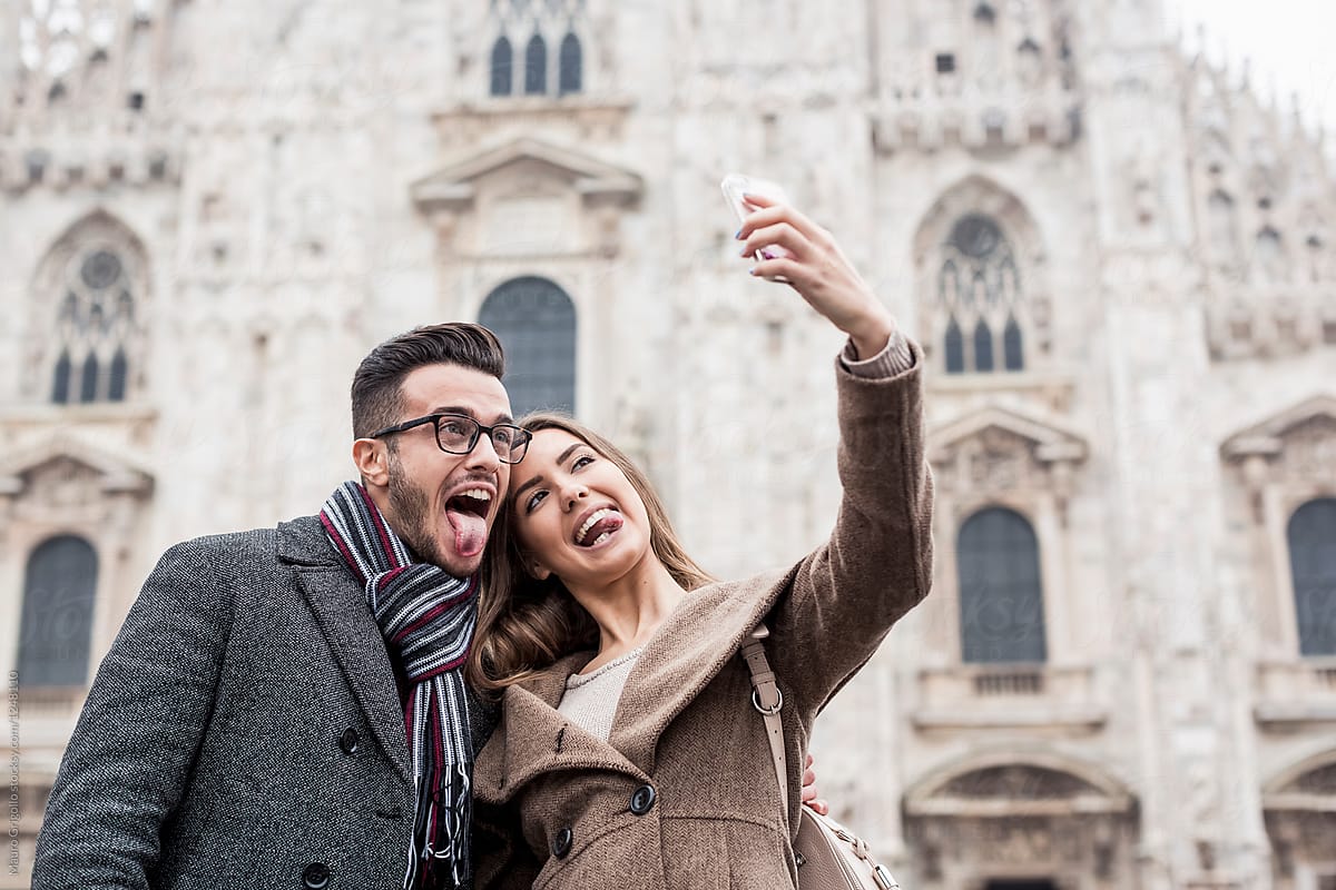 Happy couple taking a selfie in Milan, Italy.
