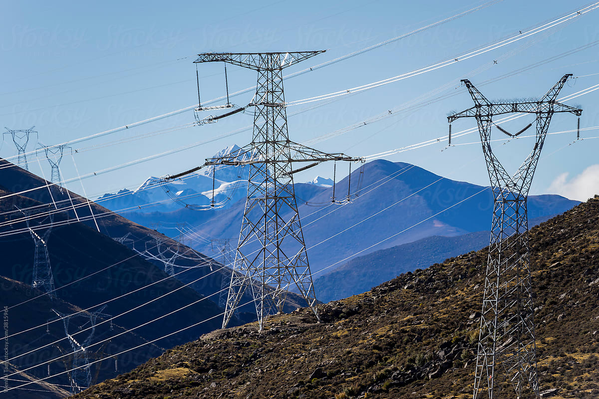 Green energy sources transmission tower and snow mountain