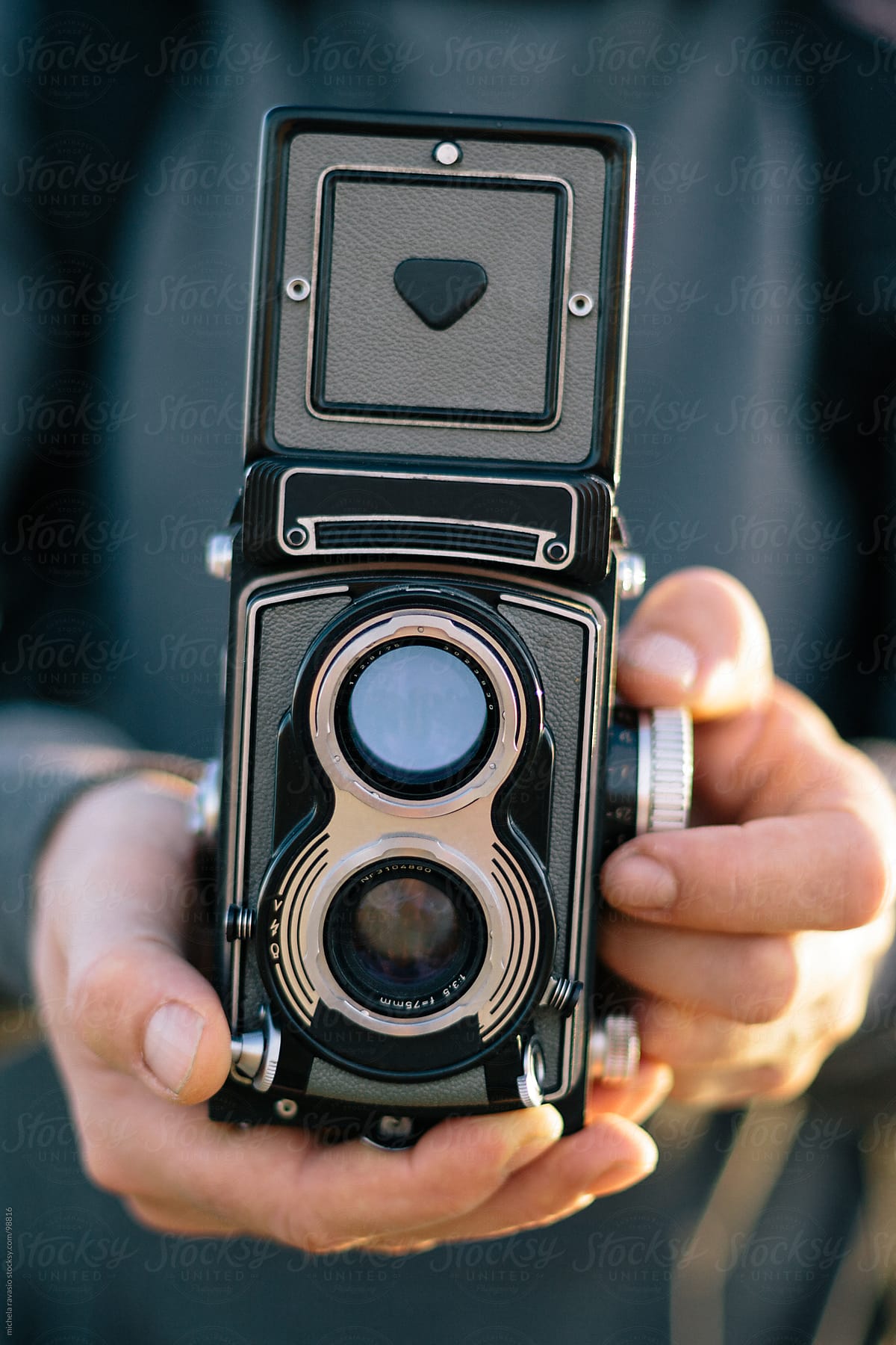 Man holding an old camera.