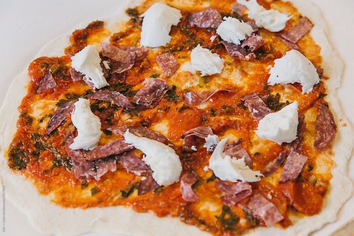 Closeup of fresh homemade pizza with mozzarella and salami
