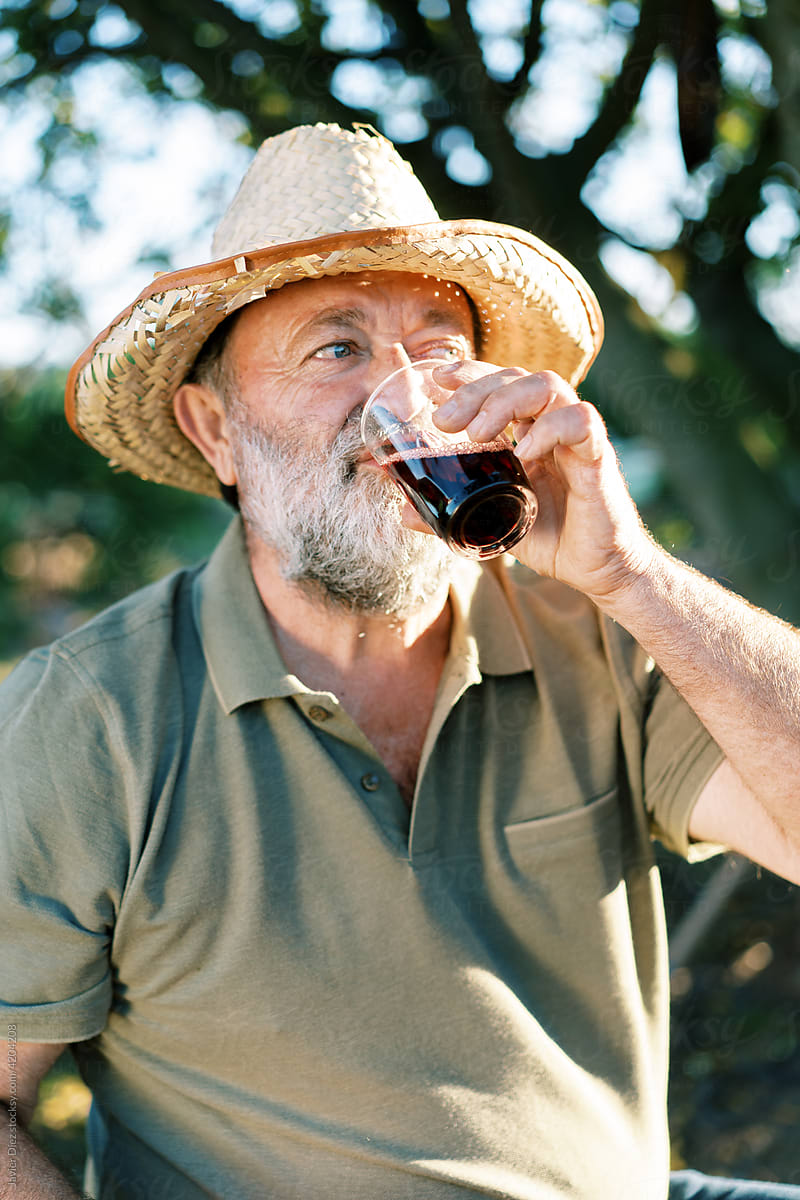Male gardener drinking wine