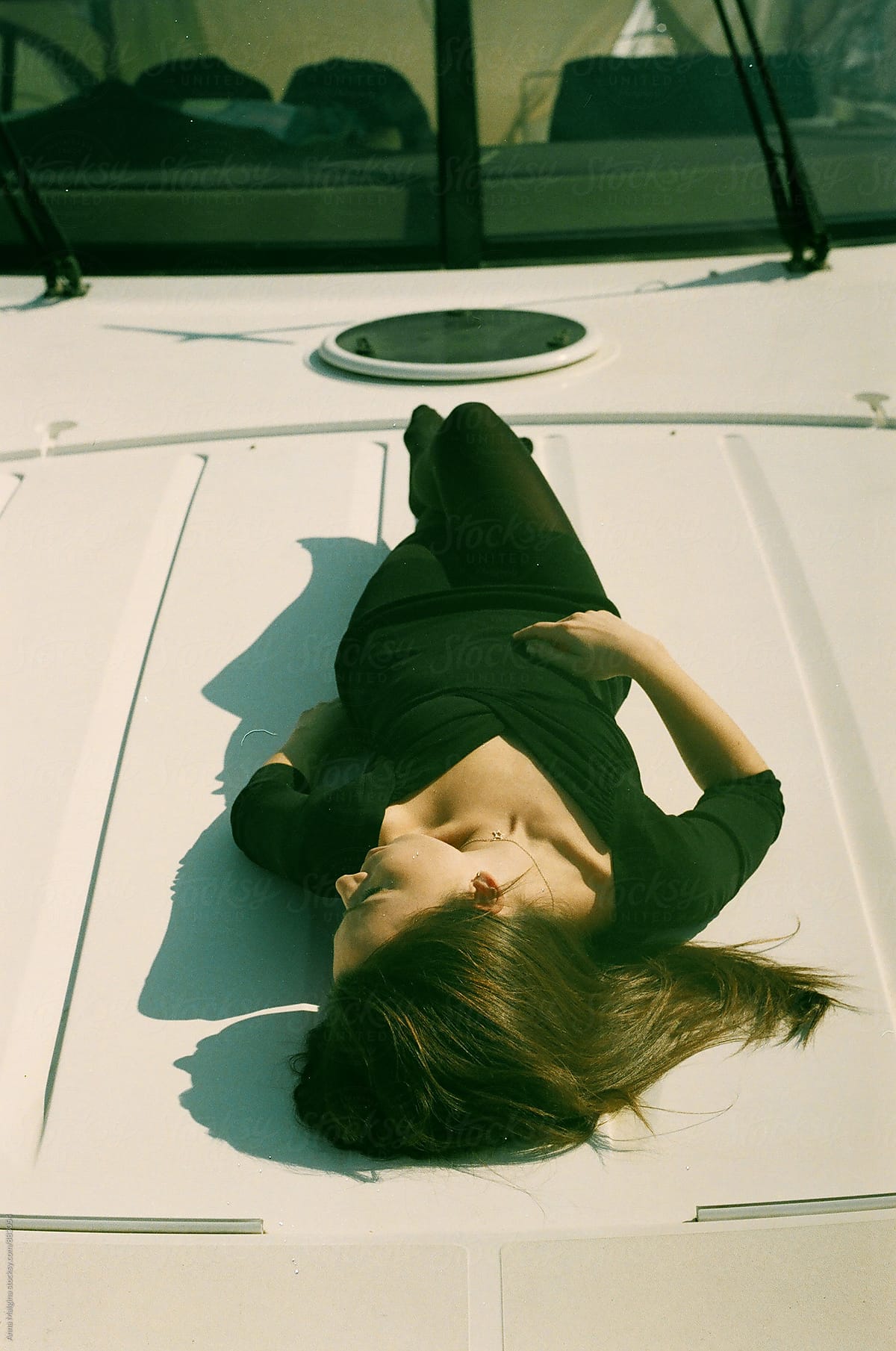 A young woman lying on the yacht
