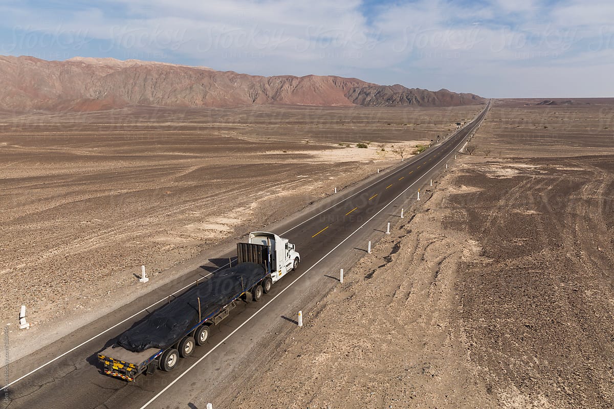 Panamericana Sur with truck, stretches away across Nazca desert Peru