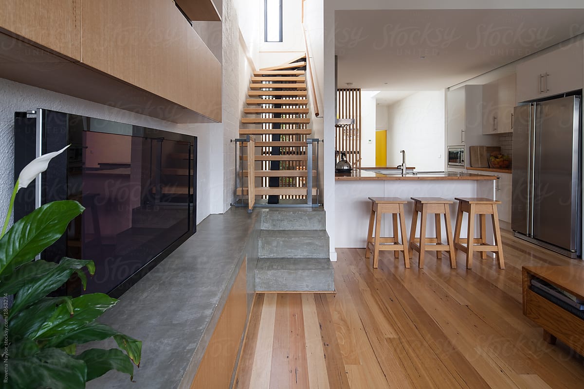 Modern conversion in loft apartment with timber stairs leading t