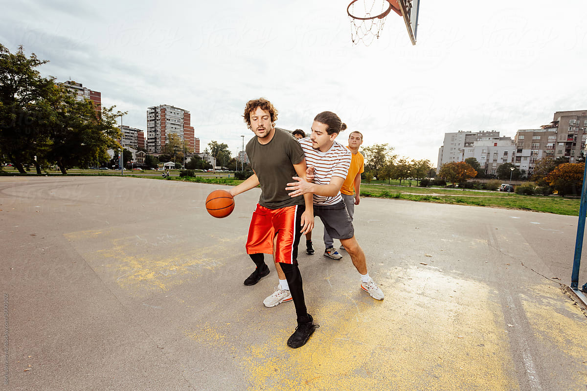 Men playing basketball outdoor
