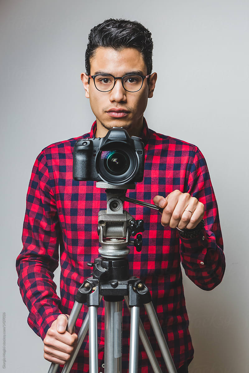 Young Photographer with a Digital Reflex Camera on a Tripod