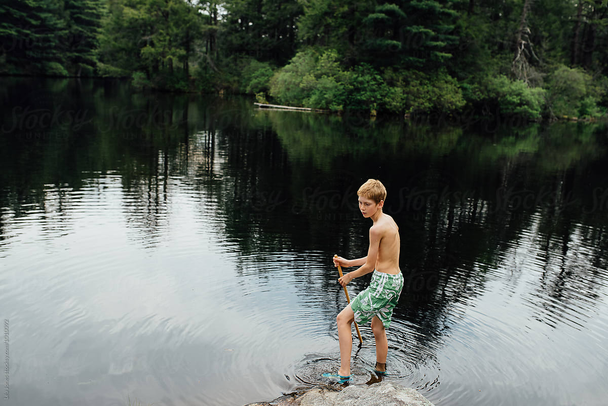 boy playing in a lake