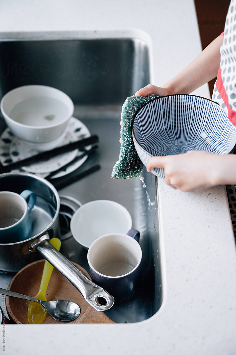 Portrait of girl washing dishes