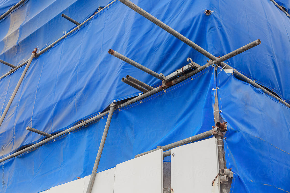 Steel and blue screen at construction site.