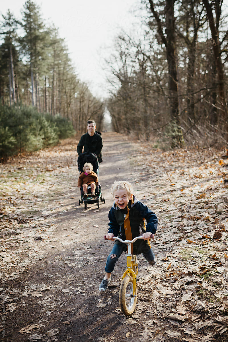 Father walking in the forest with his two children