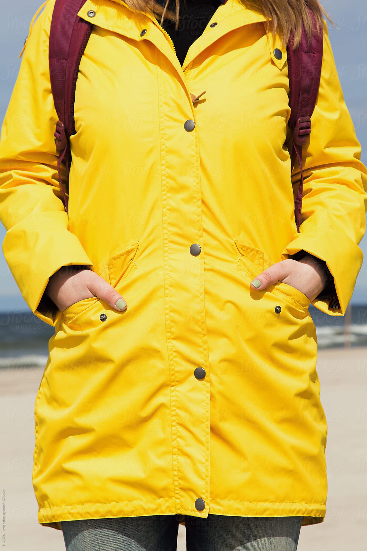 Faceless shot of woman in raincoat