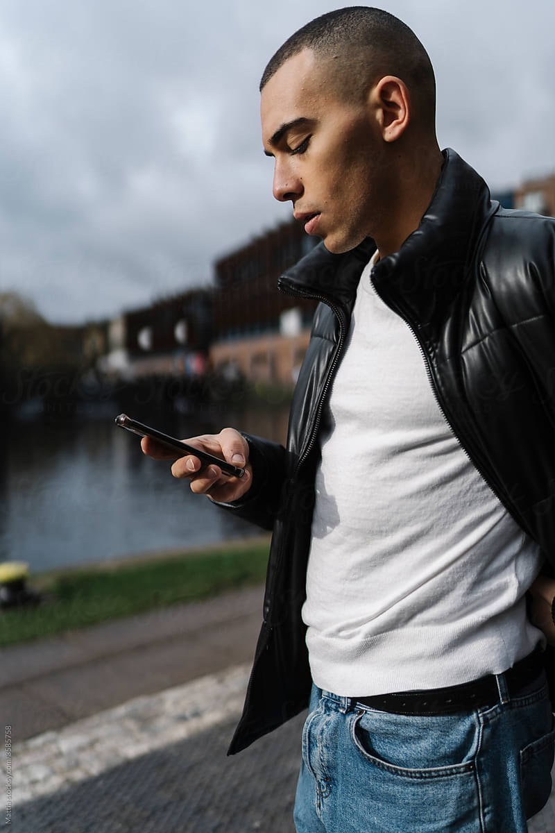 Man Using a Mobile Phone Outdoor on the City