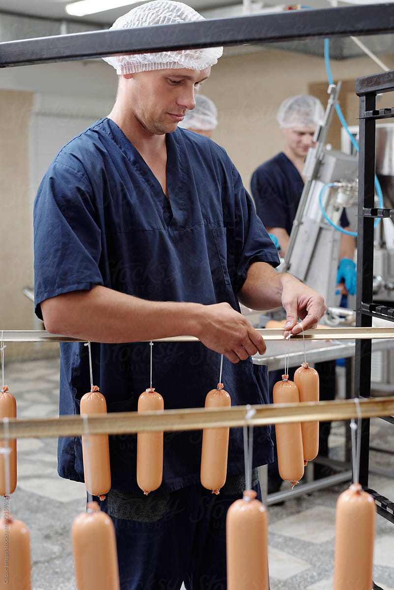 Factory Worker Hanging Sausages