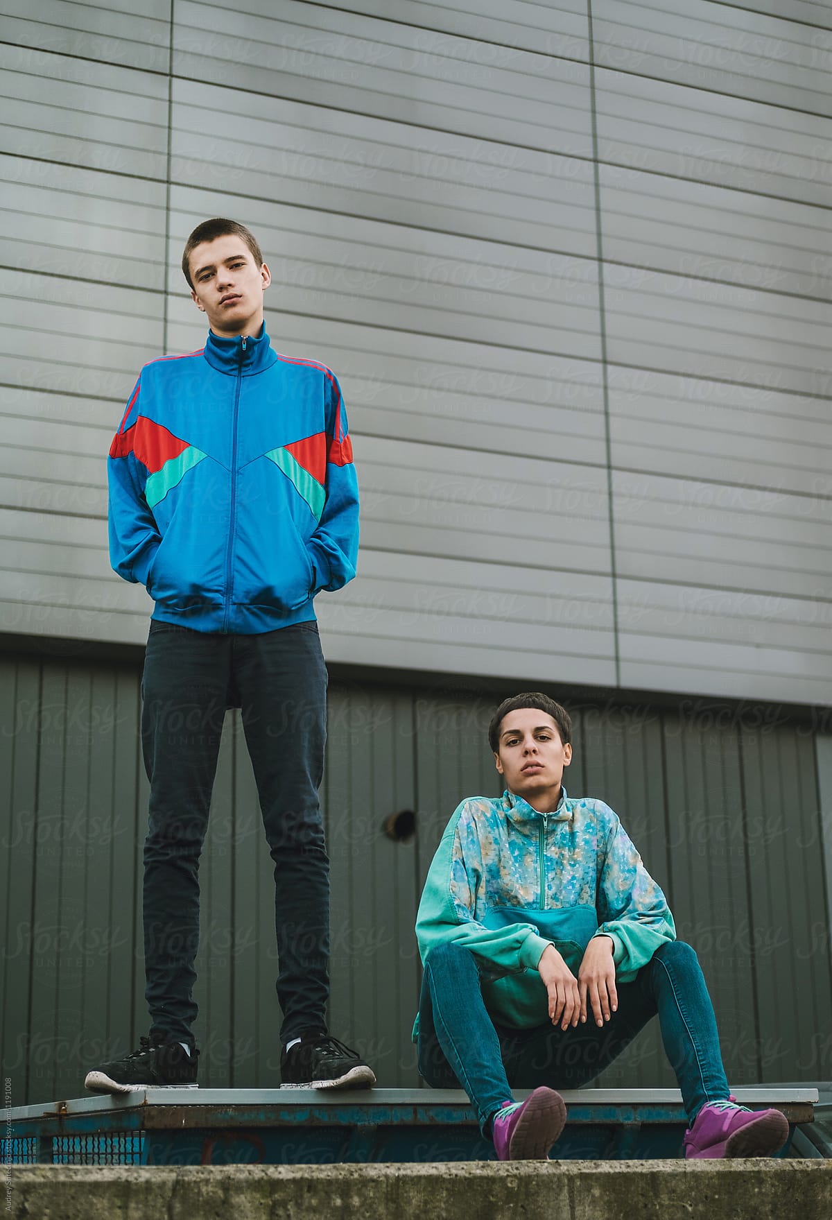 Young adolescents in colorful  track suits from 90's in east Europe projects.