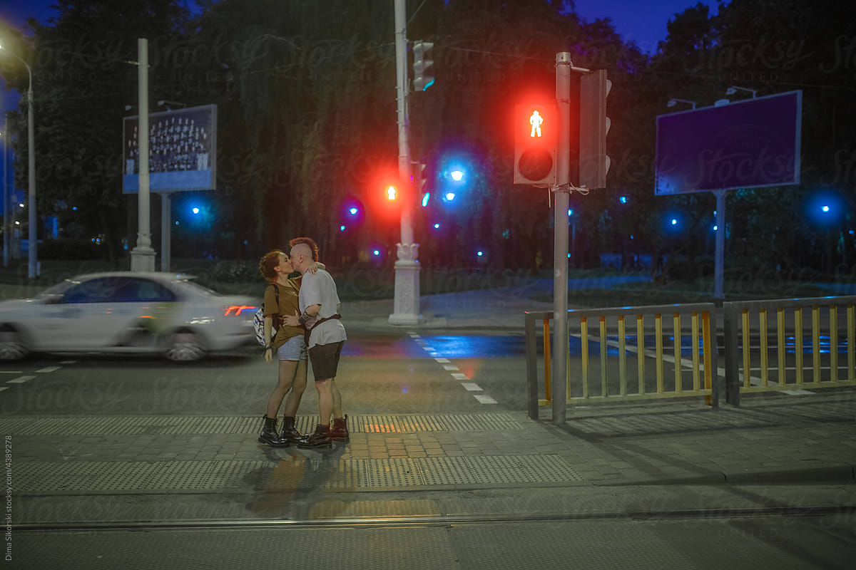 A couple in love on the roadway of a night city