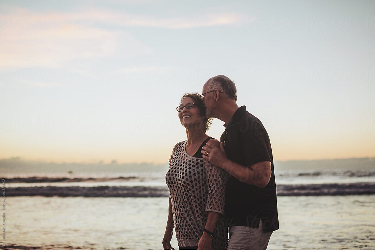 Smiling Middle Aged Man On The Beach At Sunset by Stocksy Contributor Rob  And Julia Campbell - Stocksy