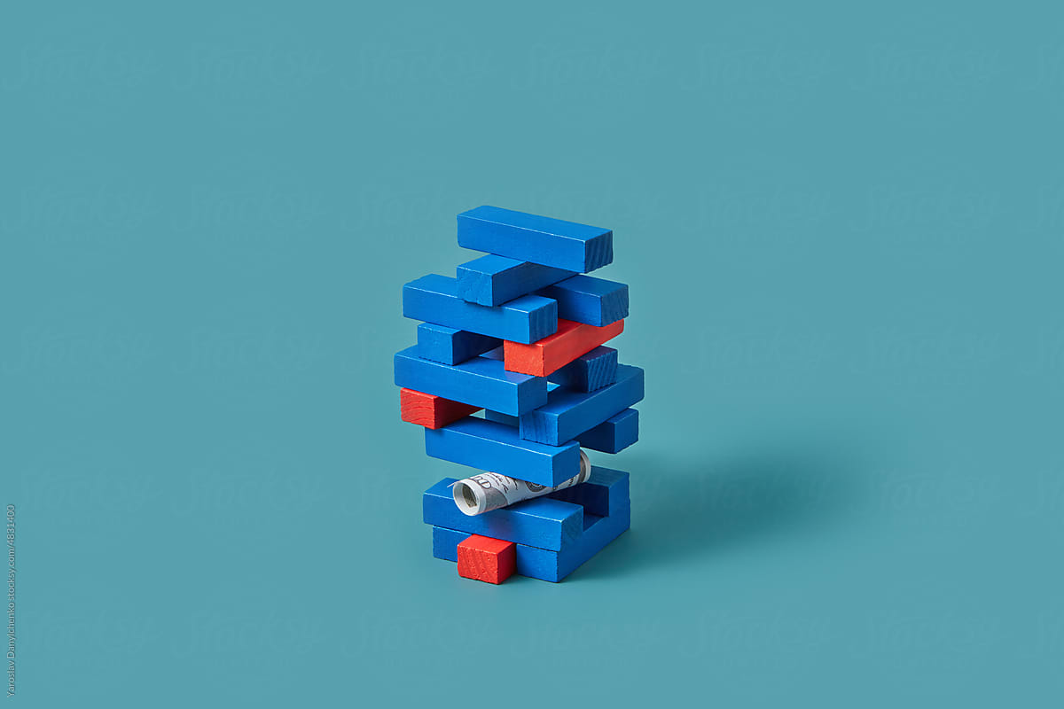 Blue and red block tower with dollars.