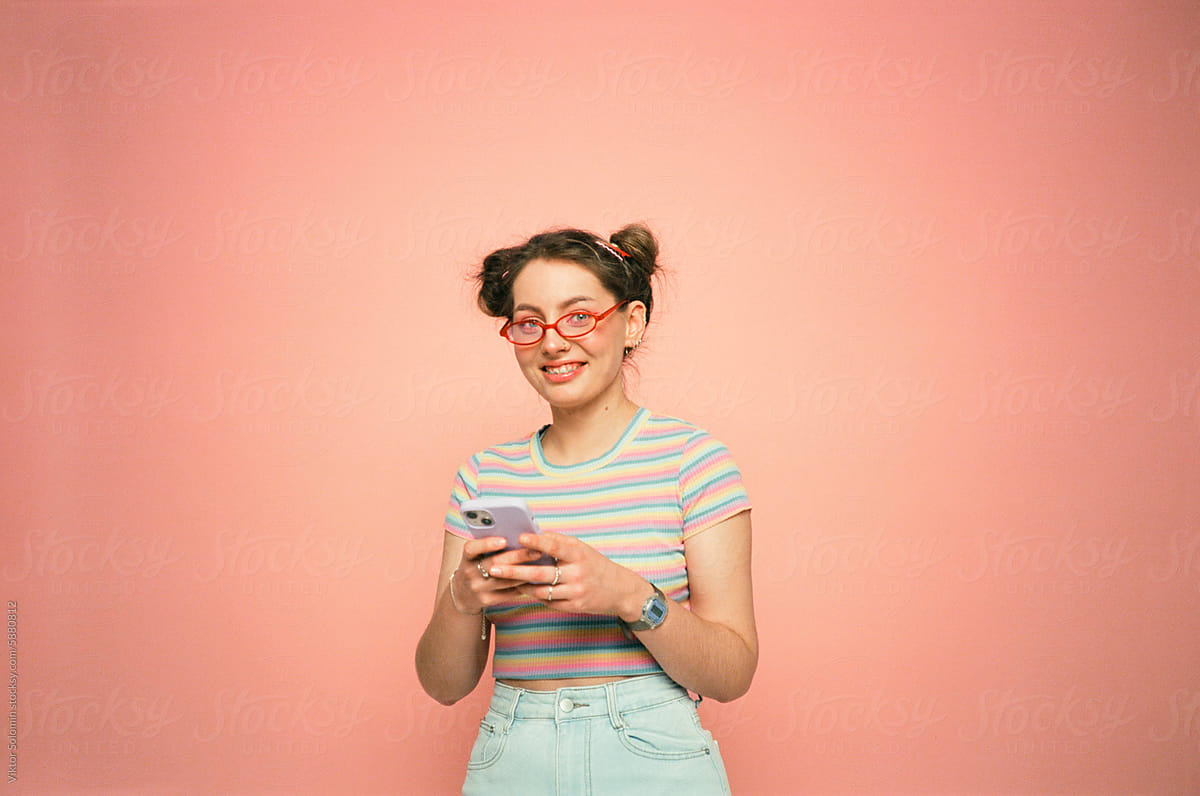 Cheerful young woman with smartphone