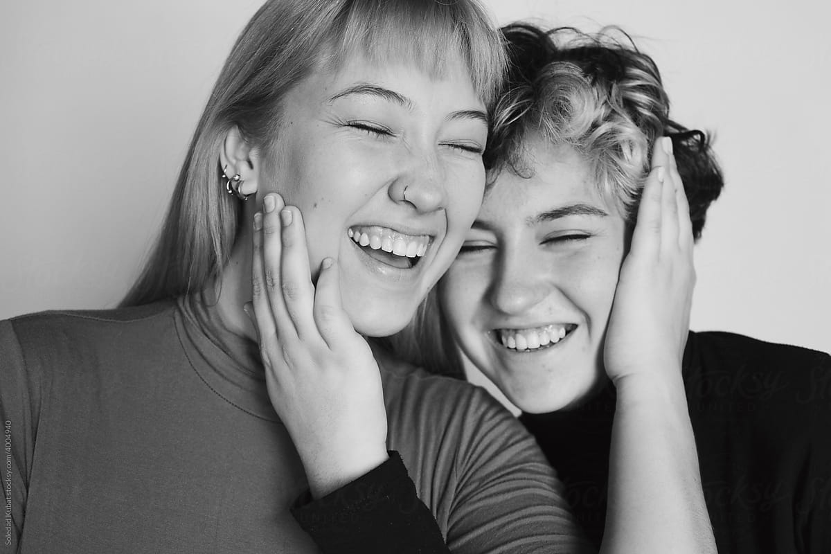 Black and white portrait of two friends smiling