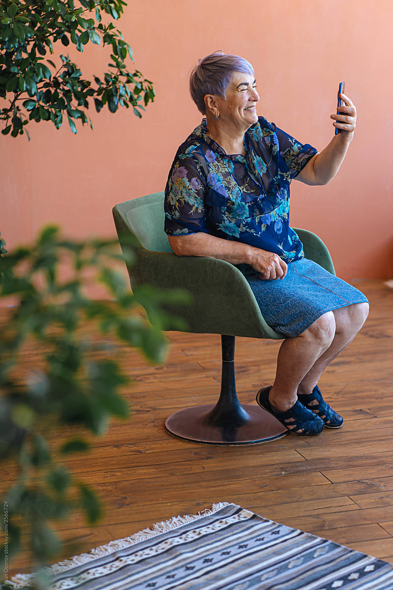 an elderly woman communicates on a video call