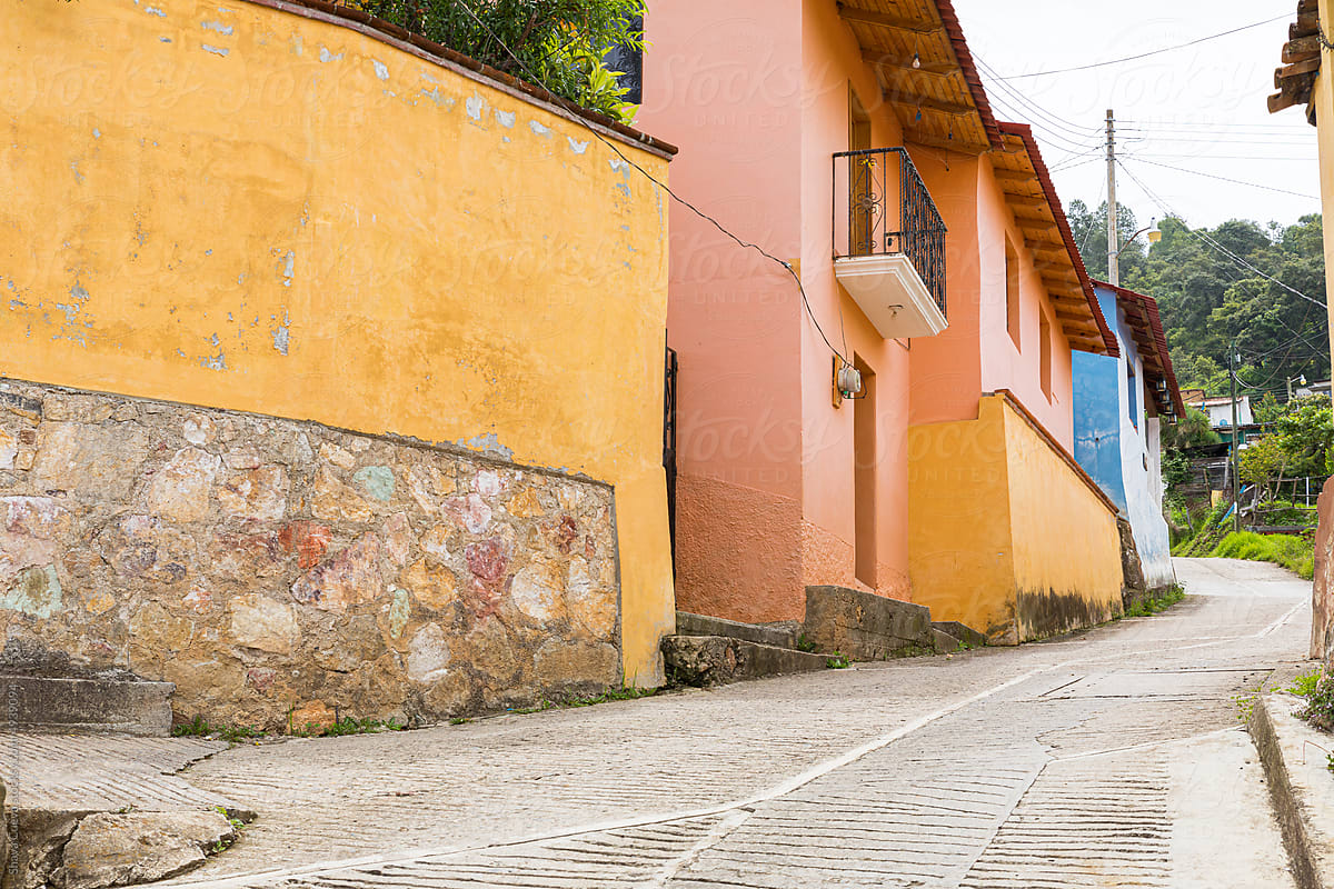 An empty street with colorful houses in a Mexican town
