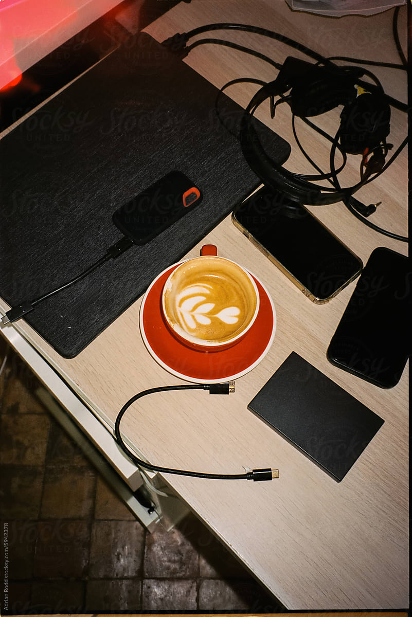 Specialty coffee at a table with video editing equipment.
