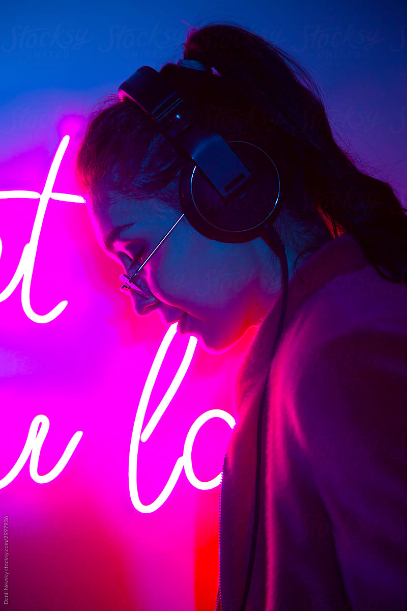 Female DJ in club with neon light