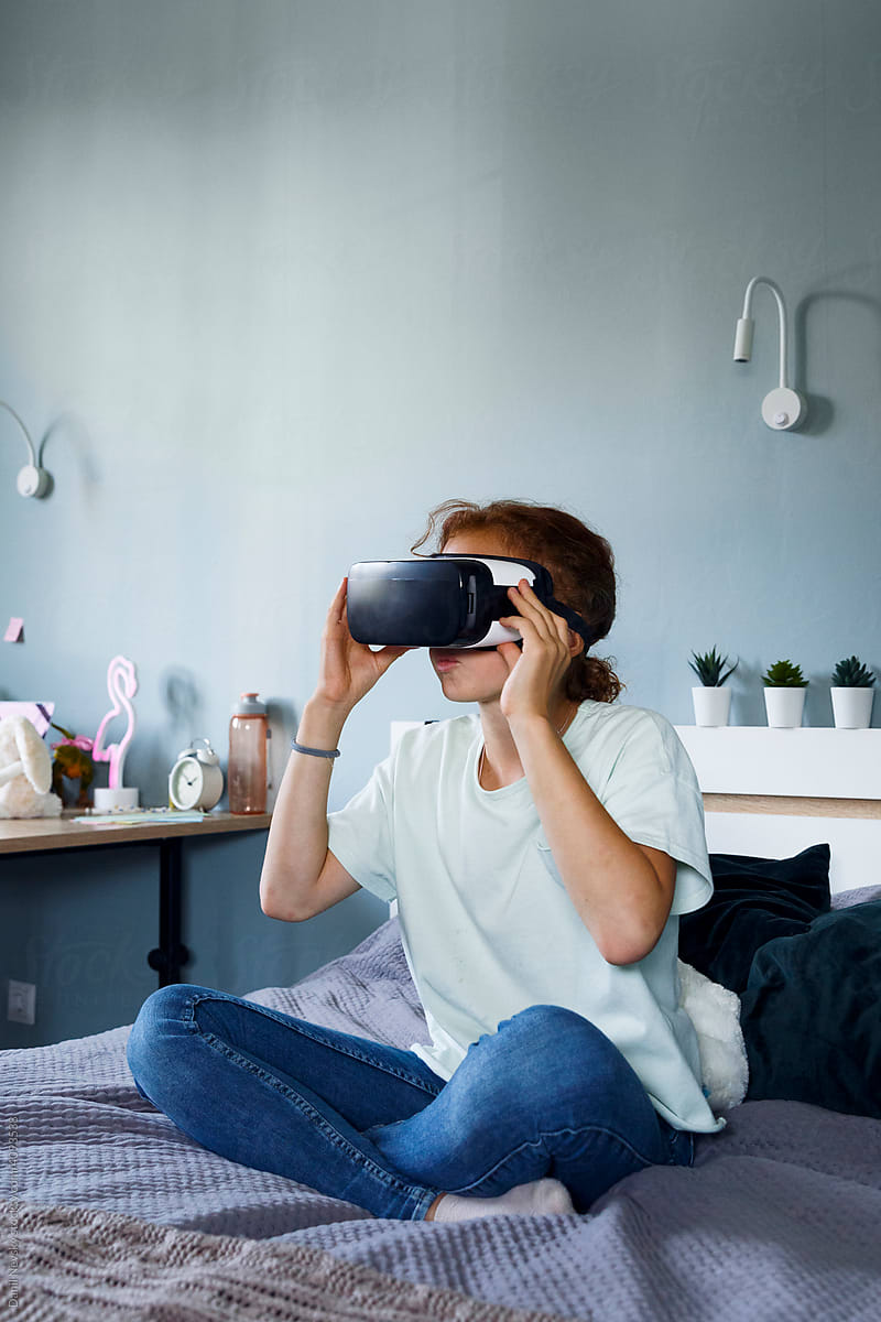 Girl in VR glasses at home