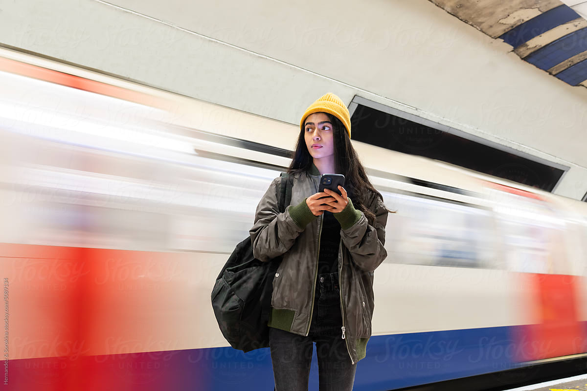 Indian Woman Holding Phone In Metro Terminal