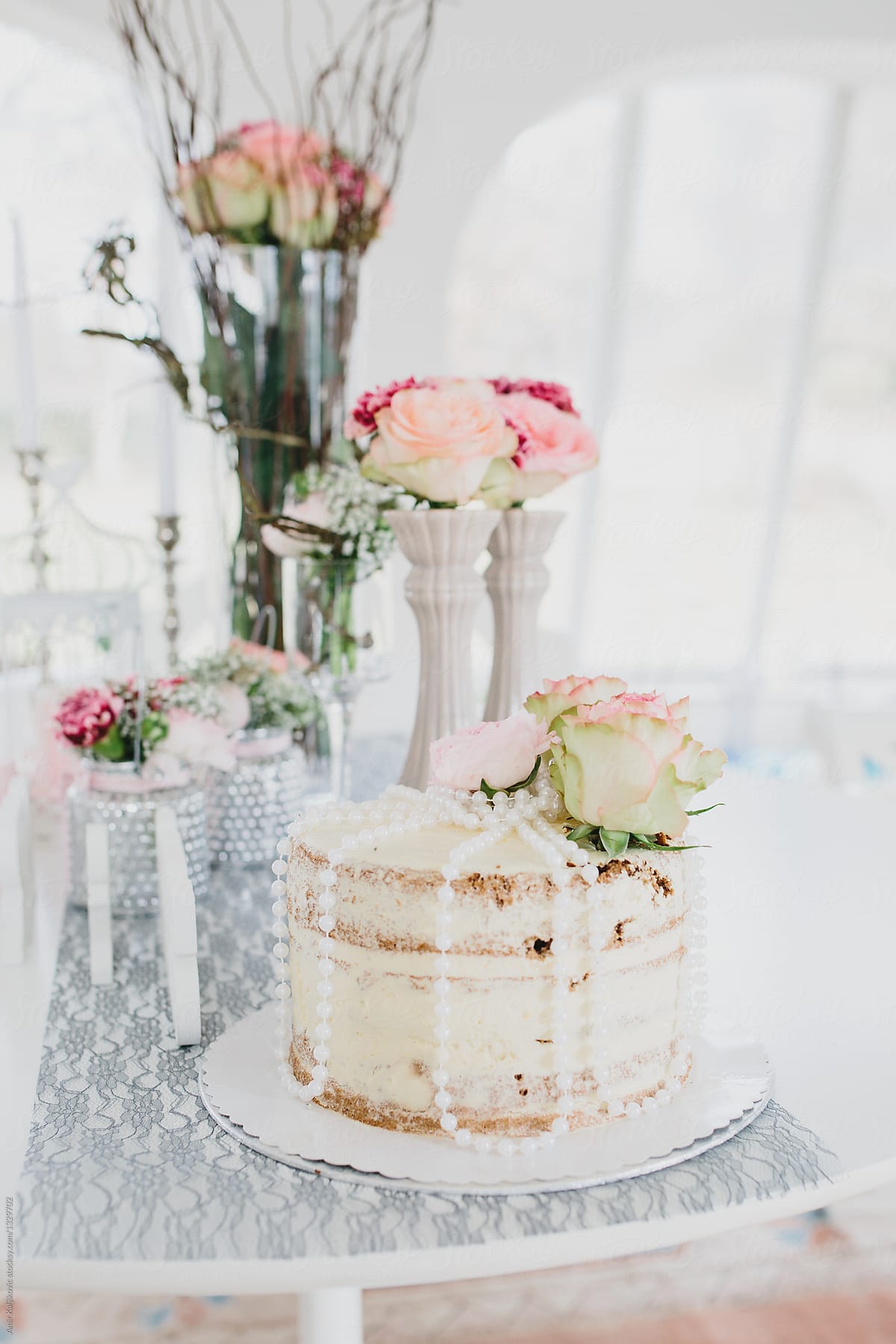 Wedding cake at reception with flower bouquet