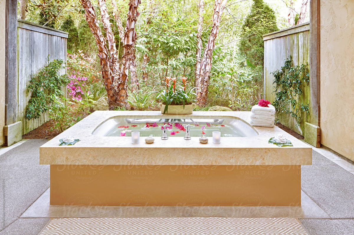 Outdoor bathtub at luxury spa with flowers