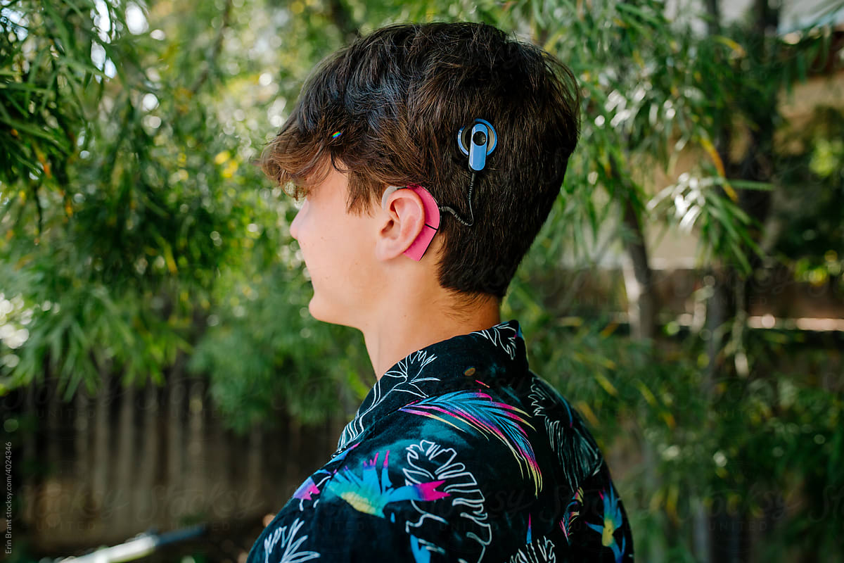 Side view of teen boy with Cochlear implants