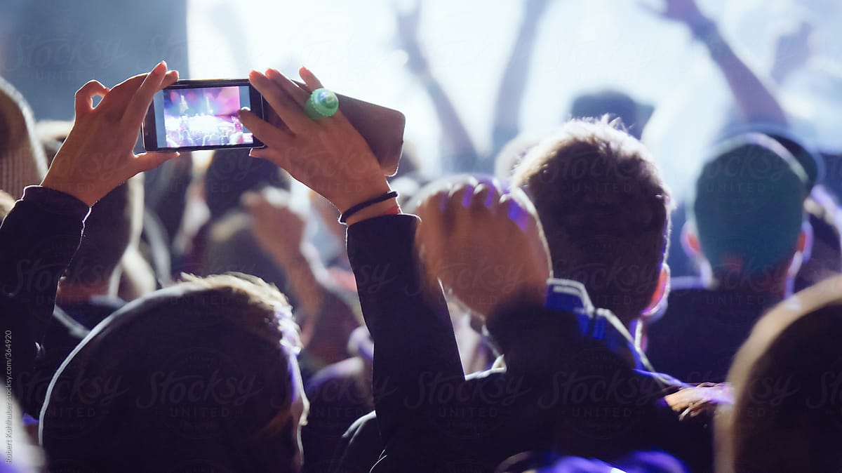 Making video with cell phone at live music concert, festival