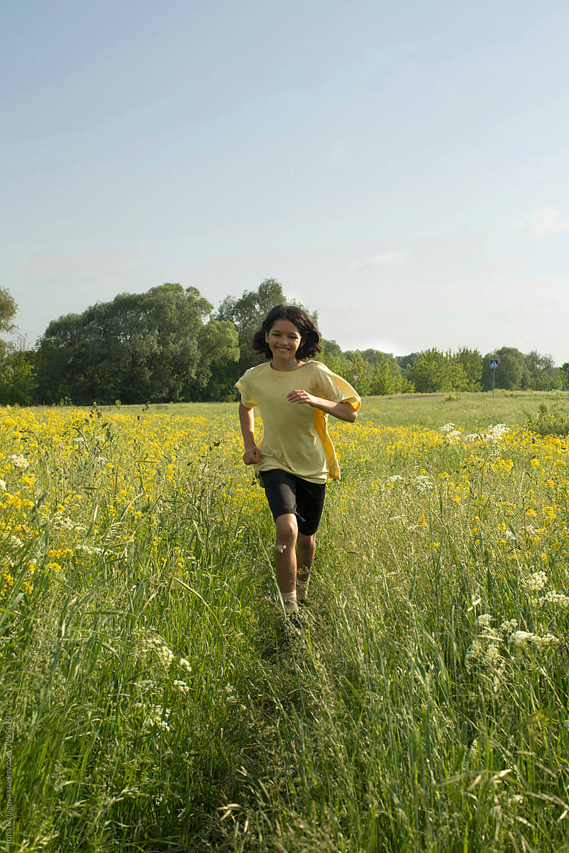 Little girl is running in a field