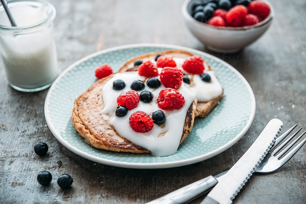 Food: vegan pancake with coconut yogurt and berries and maple sy