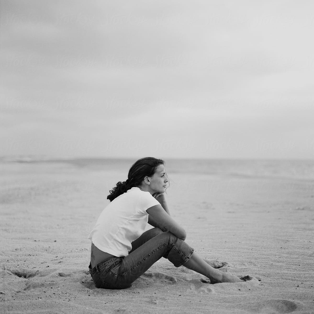 young woman sitting on the beach