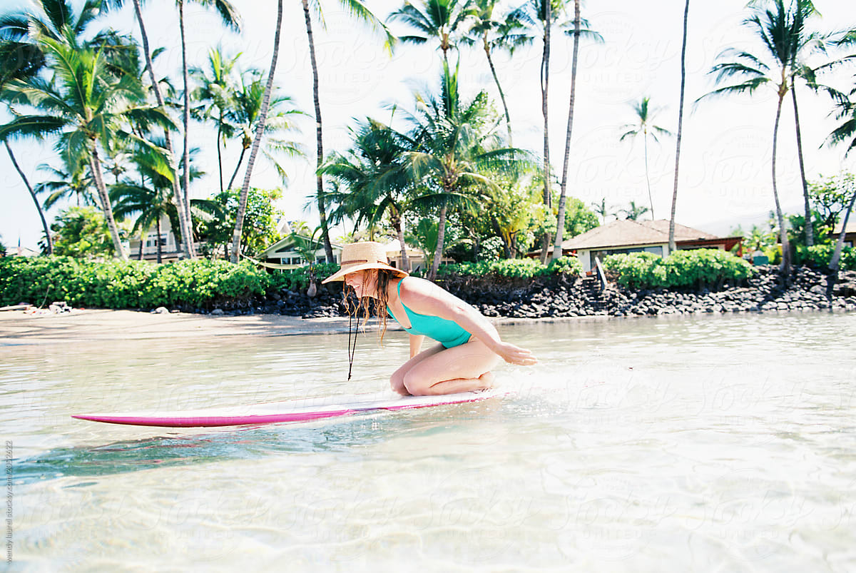 Maui surfer girl in blue ocean