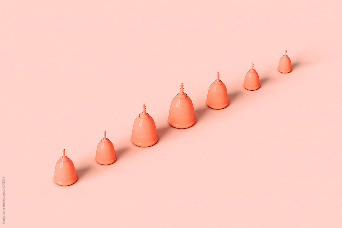 Menstrual cups on pink crossing the frame
