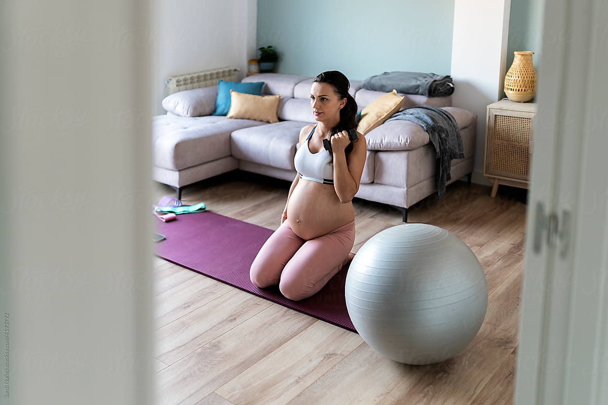 Pregnant Woman Working Out with dumbbell