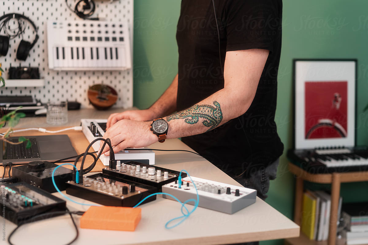 Anonymous Musician Playing Music On Synthesizers