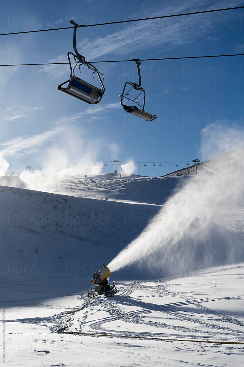 Chairlift with snow cannon in operation