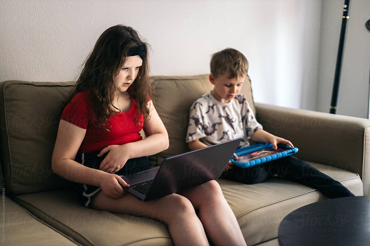 Children with laptop and tablet at home