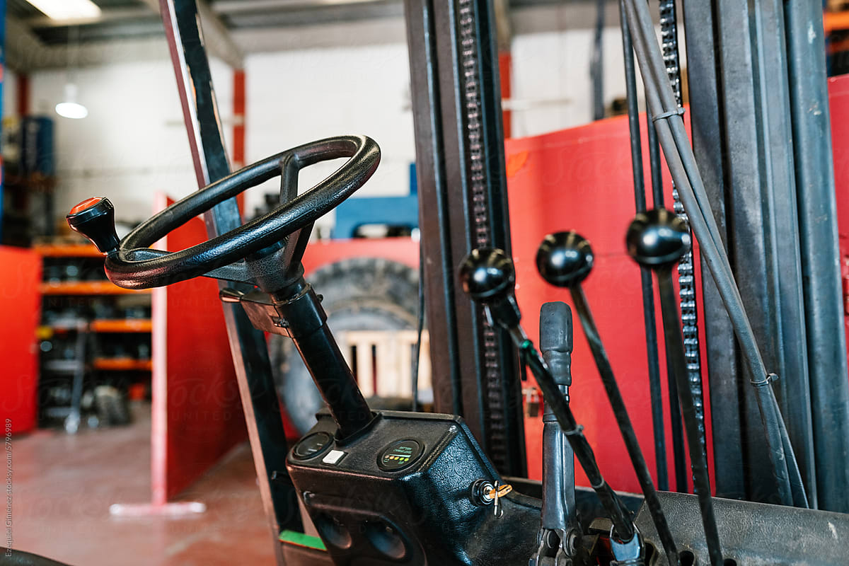Vehicle steering wheel in garage with metal handles and equipment